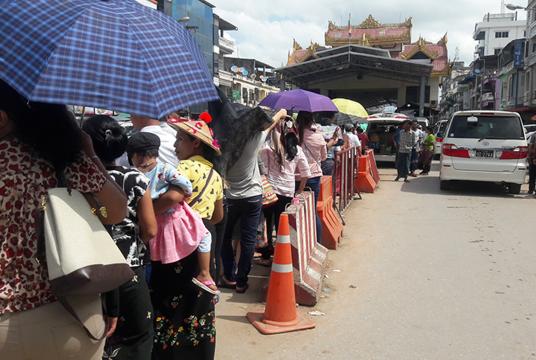 People who are queuing to make border pass at Myawady Friendship Bridge to visit Thailand