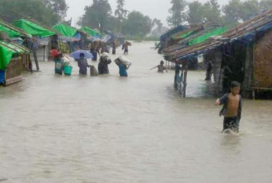 War refugees are moving their things at Thihoaye refugee camp as water entered in their camp.