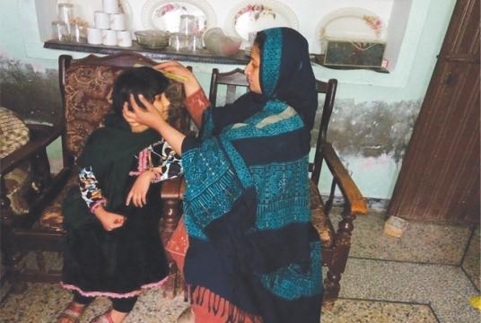 Bushra Tabassum takes care of her child as she tries to forget the trauma she suffered
