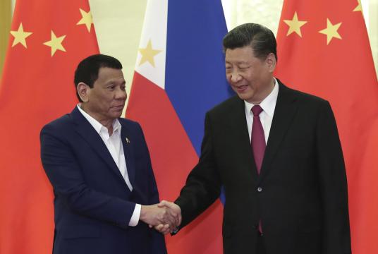 Philippine President Rodrigo Duterte, left, shakes hands with Chinese President Xi Jinping, right, before the meeting at the Great Hall of People in Beijing, China Thursday, April 25, 2019. (Kenzaburo Fukuhara/Pool Photo via AP)