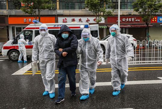 A virus-infected patient being taken by officials for health checks in Wuhan (Photo-AFP) 