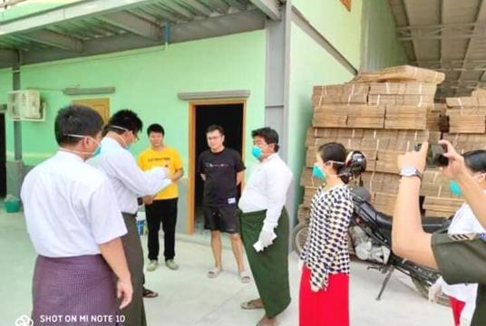 Authorities check two Chinese citizens at Shwe Thonelone carton box factory