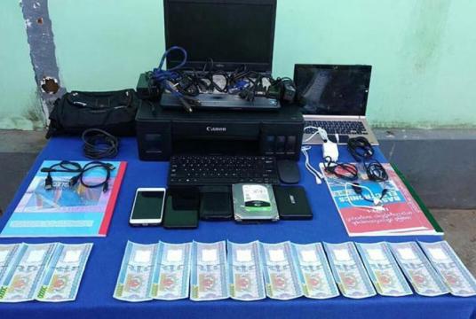 Photo show the computers, printer and accessories used for making fake banknotes seized at the Chaungtha bach on December 22
