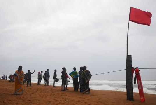 People look out towards the sea from a closed beach in Puri in Odisha on May 2, 2019, as cyclone Fani approaches the coastline. Nearly 800,000 people in eastern India have been evacuated ahead of a major cyclone packing winds gusting up to 200 kilometres (125 miles) per hour and torrential rains, officials said on May 2. (Dibyangshu SARKAR / AFP)