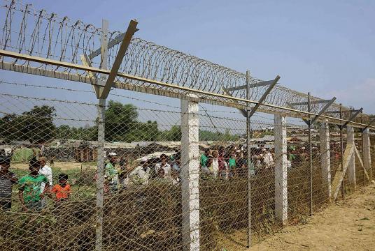 The photo shows the border fence on Myanmar-Bangladesh border and Bengalis arriving in Bangladesh. (Photo-AFP)