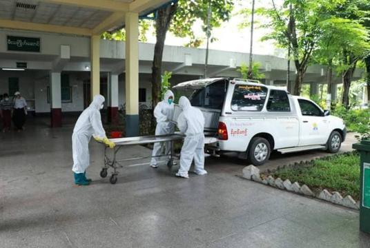 Staffers from Free Funeral Service Society (Yangon) help with cremation of a patient who died of seasonal flu at Yayway Cemetery.  