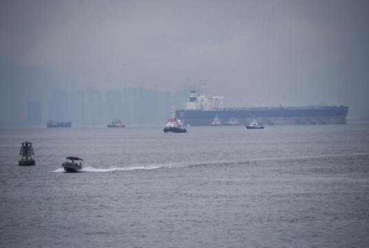  A Singapore Police Coast Guard vessel (far right) patrolling the waters off Tuas on Dec 6, 2018.ST PHOTO: MARK CHEONG