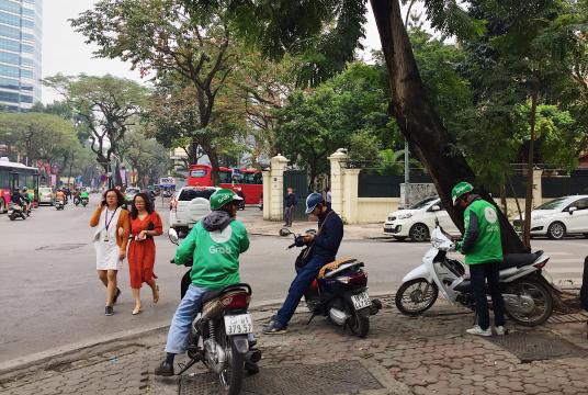 Driving for ride-hailing services is a new kind of freelancing in Vietnam. 