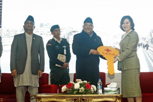 Chinese Ambassador to Nepal Hou Yanqi hands over a symbolic key to Prime Minister KP Sharma Oli during a handover ceremony of the recently completed Koteshwor-Kalanki road in the Capital. Post Photo: Keshav Thapa