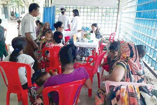 Healthcare workers seen providing public healthcare in Rakhine State. 