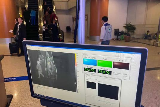 Travellers take screening tests at Yangon International Airport. 