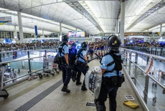 In a picture from Aug 13, 2019, police officers and protesters face off at Hong Kong International Airport.PHOTO: NYTIMES