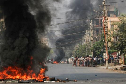 Tyres burn on a street as protests against Myanmar's coup continue in Mandalay on March 27, 2021.PHOTO: REUTERS