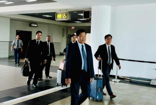 Union Minister U Than Swe seen leaving for a foreign trip.