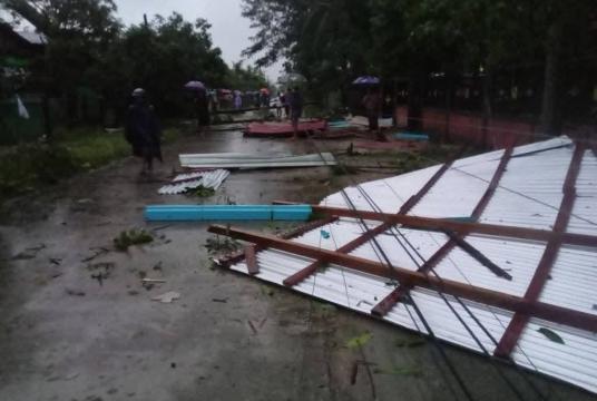 Homes and power poles damaged after a tornado struck Nyaung Waing village in Paung Township.