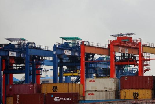 An international port in Yangon where export and import cargo containers are being handled.