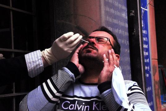A man gives swab samples for COVID-19 testing at the District magistrate office (SDM) Lajpat Nagar in New Delhi. (Photo: IANS)