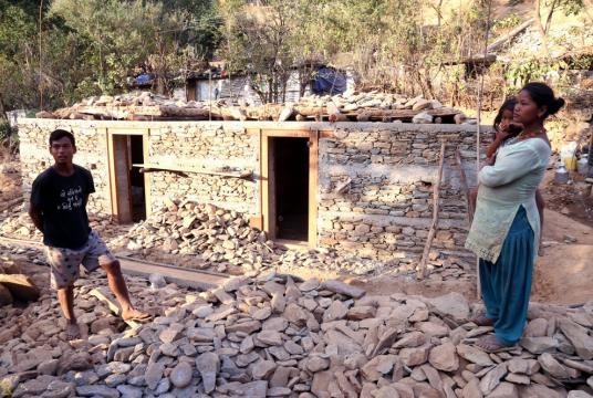 Keshav Majhi and his family in front of their under-construction house in Ramechhap in 2017. Post File Photo