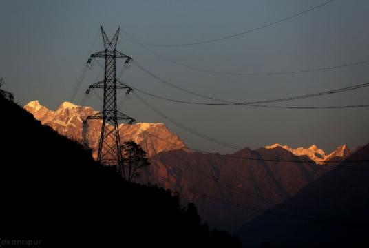 A 220 KV double circuit transmission line against the backdrop of the Gaurishankar mountain, which is the source of the Tamakoshi river 