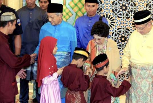 Dr Mahathir and Dr Siti Hasmah shaking hands with visitors at their Raya open house at Seri Perdana in Putrajaya. — LOW LAY PHON/The Star