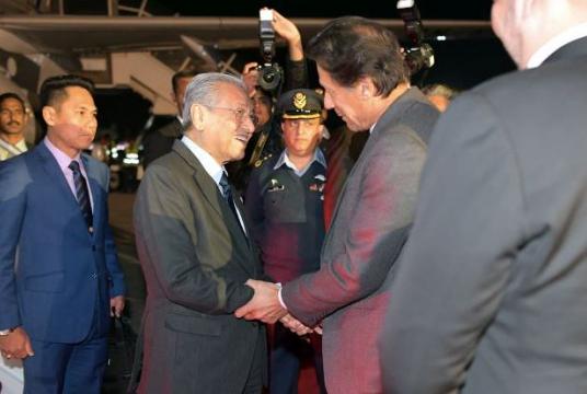 Imran greeting Dr Mahathir at the Nur Khan Airbase in Rawalpindi, Pakistan. — Bernama