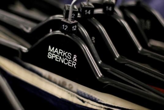 Clothes are displayed on hangers in an Marks & Spencer shop in northwest London, Britain July 8, 2014. Photo: REUTERS/Suzanne Plunkett/File Photo