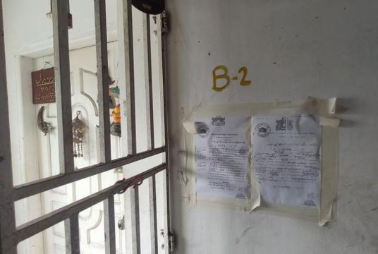 A warrant stuck on the wall of Min Ko Naing’s flat. 