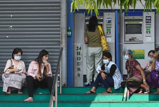 eople wait to withdraw money from a Myawaddy Bank automated teller machine (ATM) in Yangon on February 23, 2021. (Agence France Presse/Sai Aung Main) 