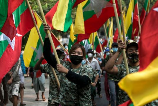 Military supporters carry Myanmar’s national flags during a demonstration in Yangon shortly before the military detained the country’s de facto leader Aung San Suu Kyi and the country’s president in a coup. Photo: AFP