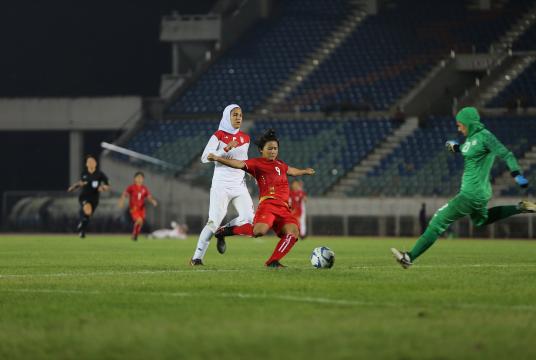 Myanmar (white) vies with Laos (red) for the ball in second match of Group-F first round qualification. (MFF)