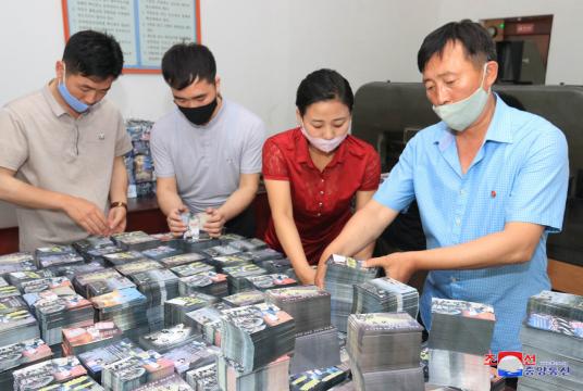In this photo, North Koreans are preparing anti-Seoul leaflets at an undisclosed location.(KCNA-Yonhap)