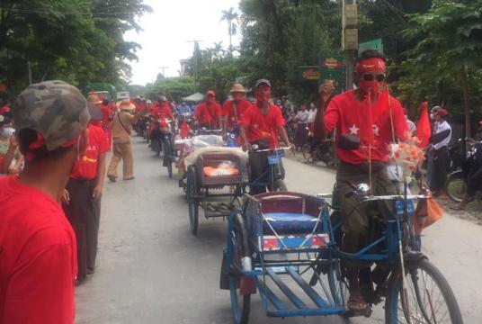 Trishaw men going round in Hinthada Township in support of NLD at the ceremony to erect its election campaigning billboard on September 8  
