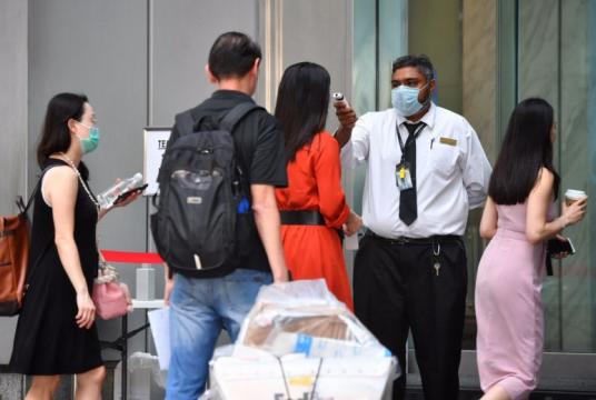 People queuing up to get their temperatures checked at One Raffles Place on Feb 10, 2020.ST PHOTO: CHONG JUN LIANG