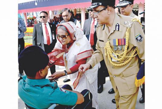 Prime Minister Sheikh Hasina presents an injured policeman with a medal on the first day of the Police Week-2019 at the capital's Rajarbagh Police Lines yesterday. Photo: PID