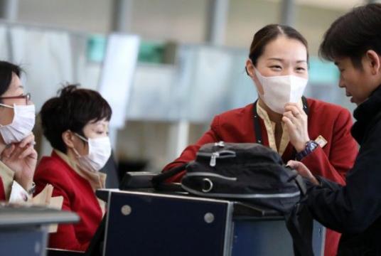 Cathay Pacific ground staff wear face masks at the check-in counters at Hong Kong International Airport. Photo: Nora Tam