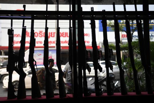 Guns are set up in a window display at the Ratchasima Gun Shop, located near the Terminal 21 shopping mall where a mass shooting took place in the northeastern Thai city of Nakhon Ratchasima, on February 10, 2020. Grieving relatives of 29 people murdered by a rogue soldier in Thailand held Buddhist prayer ceremonies on February 10, as questions multiply over how and why the unprecedented shooting spree happened. (CHALINEE THIRASUPA / AFP) 