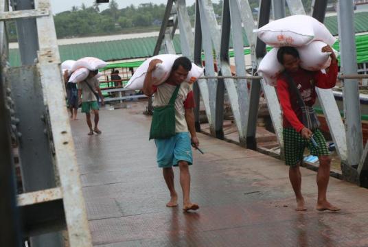 Caption_ Loading and unloading of rice bags at Wardan Jetty in Yangon