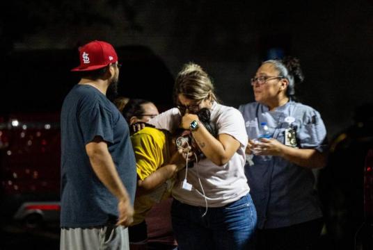 A family grieving outside of the Willie de Leon Civic Centre following the shooting in Uvalde, Texas, on May 24, 2022. PHOTO: AFP