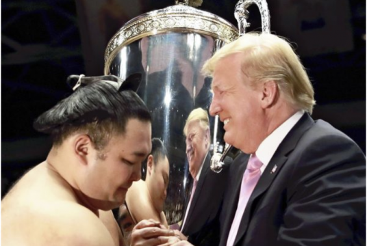 U.S. President Donald Trump presents the “President’s Cup” to Summer Grand Sumo Tournament winner Asanoyama at Ryogoku Kokugikan in Tokyo on Sunday./The Japan News