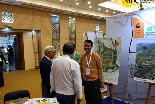 NYDC CEO Theim Wai (left) seen at the Invest Myanmar Summit 2019 at the booths for the New Yangon City Project. (Photo - NYDC)