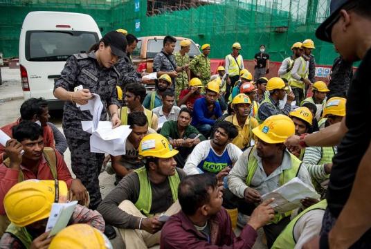 Immigration Department personnel during a raid at a construction site in Kuala Lumpur on Sept 26 to crack down on undocumented foreign workers. Malaysia needs a steady supply of unskilled workers and must repair the damage to the country's reputation as a dangerous place for foreign workers.PHOTO: BERNAMA
