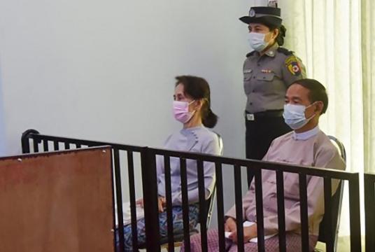 This file handout photo taken on May 24, 2021 and released by Myanmar's   Ministry of Information on May 26 shows detained civilian leader Aung San Suu Kyi (left) and   detained president Win Myint (right) during their first court appearance in Naypyidaw, since the   military detained them  on February 1. (AFP/Handout)