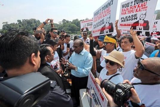 NGO members handing the memorandum urging the sacking of Saifuddin and Thomas to an officer (in blue shirt) of de facto law minister Datuk Liew Vui Keong in Kuala Lumpur./The Star
