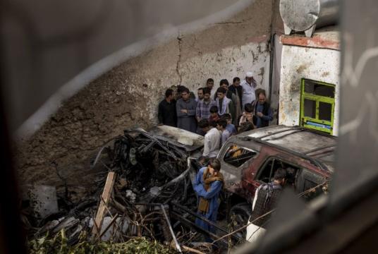 Relatives and neighbours gather near damage from a US drone strike in the courtyard of Zemari Ahmadi's home in Kabul, Afghanistan, on Aug 30, 2021.PHOTO: NYTIMES