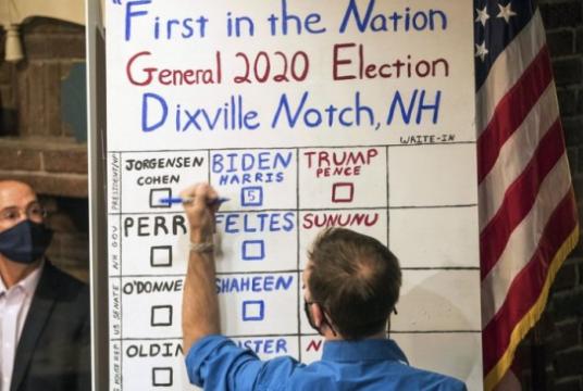 A man tallies the votes from the five ballots cast just after midnight, Tuesday, November 3, 2020, in Dixville Notch, N.H. Democratic presidential candidate and former Vice President Joe Biden received all five votes. Photo: AP