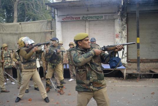 Security personnel fire teargas during demonstrations against India's new citizenship law in Meerut on December 20, 2019 (Photo by STR / AFP)