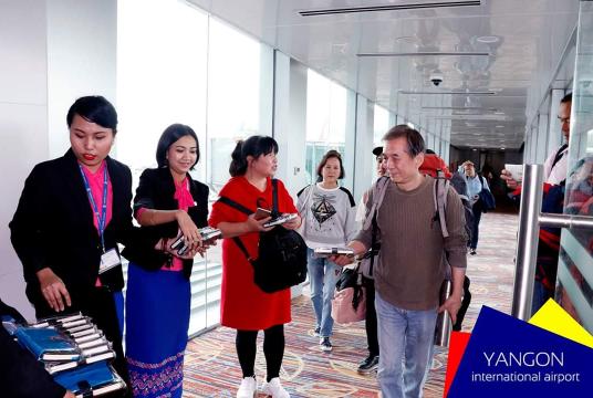 Foreigners arrive at Yangon International Airport.