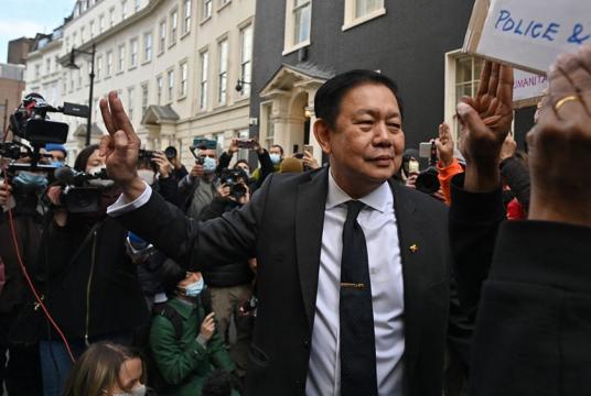 Myanmar's Ambassador to the United Kingdom, Kyaw Zwar Minn gestures outside the Myanmar Embassy in London on April 8, 2021. Britain on Thursday condemned (AFP/Ben Stansall)
