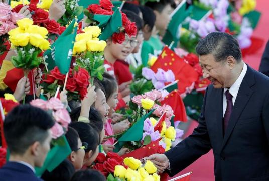 Chinese President Xi Jinping greeting children holding Chinese and Macau flags on arrival in Macau yesterday, ahead of the 20th anniversary of the former Portuguese colony's return to China. During his three-day visit, Mr Xi is expected to announce a raft of policies aimed at diversifying the city's gaming-focused economy.PHOTO: REUTERS