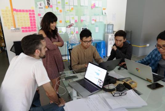 Ye Myat Min, co-founder and CEO of Nexlabs (middle, wearing glasses), works on a new product together with team members